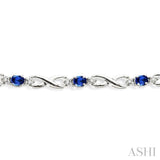 4x3 MM Oval Cut Sapphire and 1/10 ctw Single Cut Diamond Bracelet in 10K White Gold