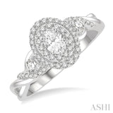 5/8 ctw Split Twisted Shank Round Cut Diamond Engagement Ring With 1/4 ctw Oval Cut Center Stone in 14K White Gold